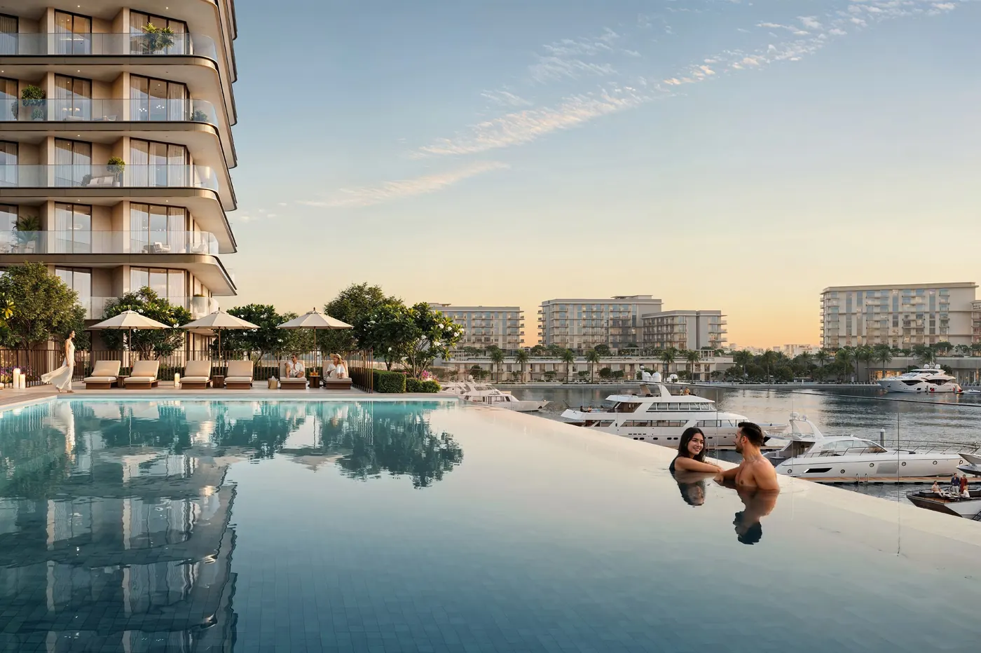 An infinity pool overlooking the marina at sunset